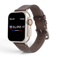Clipz It Rancher brown full-grain leather strap on an Apple Watch with an aged steel buckle and contrast stitching.